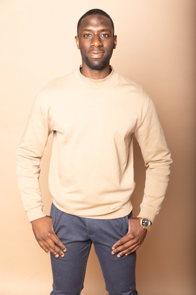 Jonathan standing, and smiling proudly.